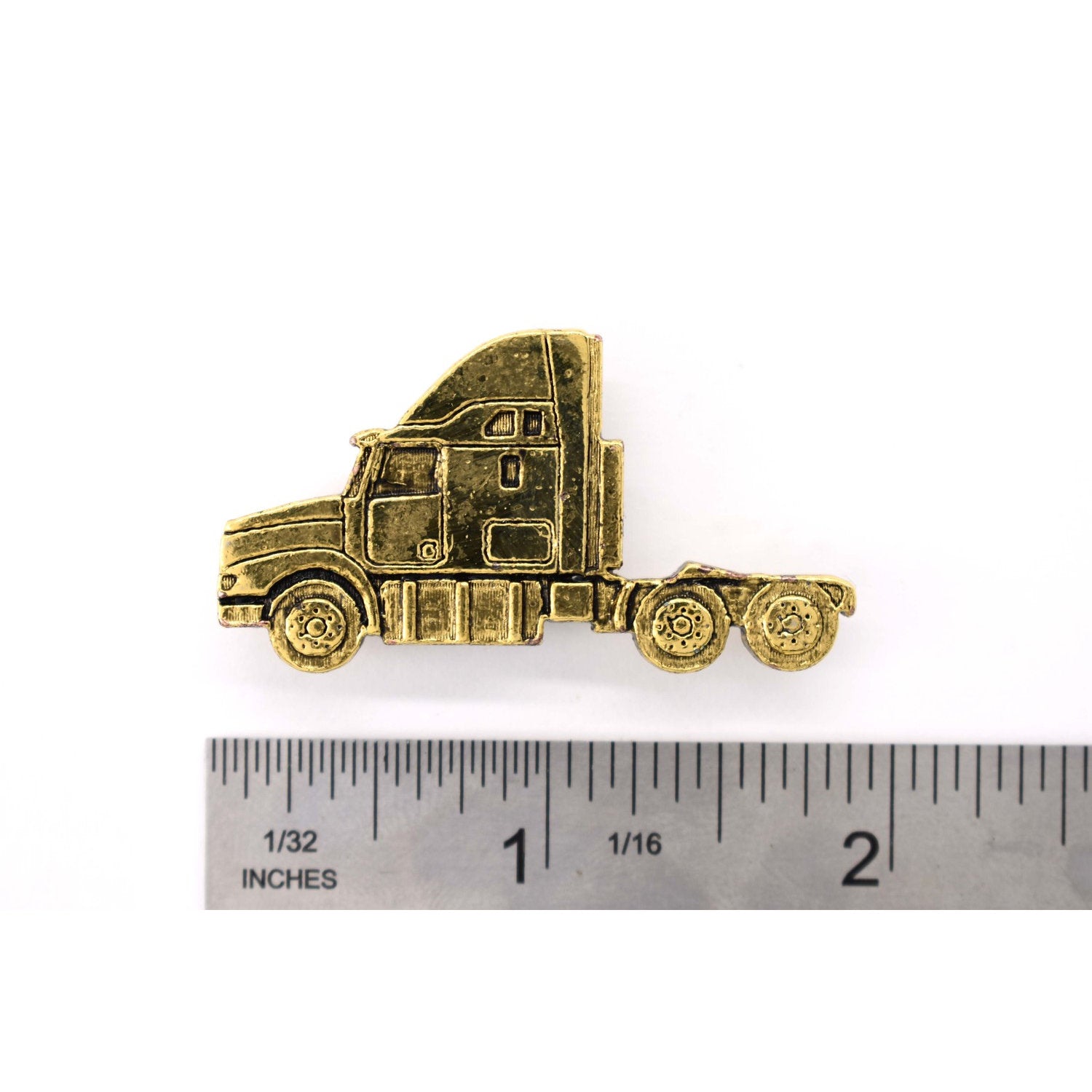 A handcrafted Semi Truck Long Nose Pin next to a ruler, available for sale at Creativeartisan.com - the image offers a sense of scale