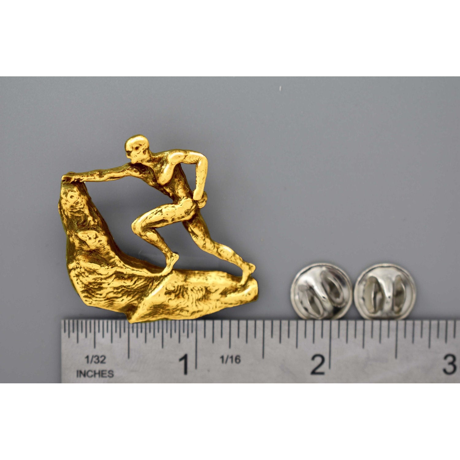 A handcrafted Rock Climber Male Pin next to a ruler, available for sale at Creativeartisan.com - the image offers a sense of scale