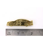 A handcrafted Race Car Pin next to a ruler, available for sale at Creativeartisan.com - the image offers a sense of scale
