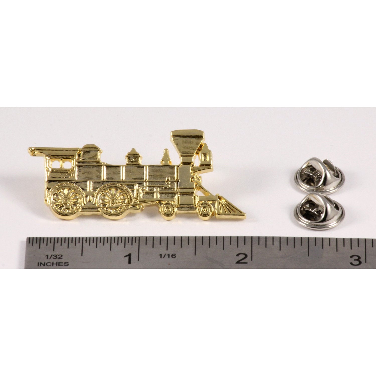 A handcrafted Train Engine Pin next to a ruler, available for sale at Creativeartisan.com - the image offers a sense of scale