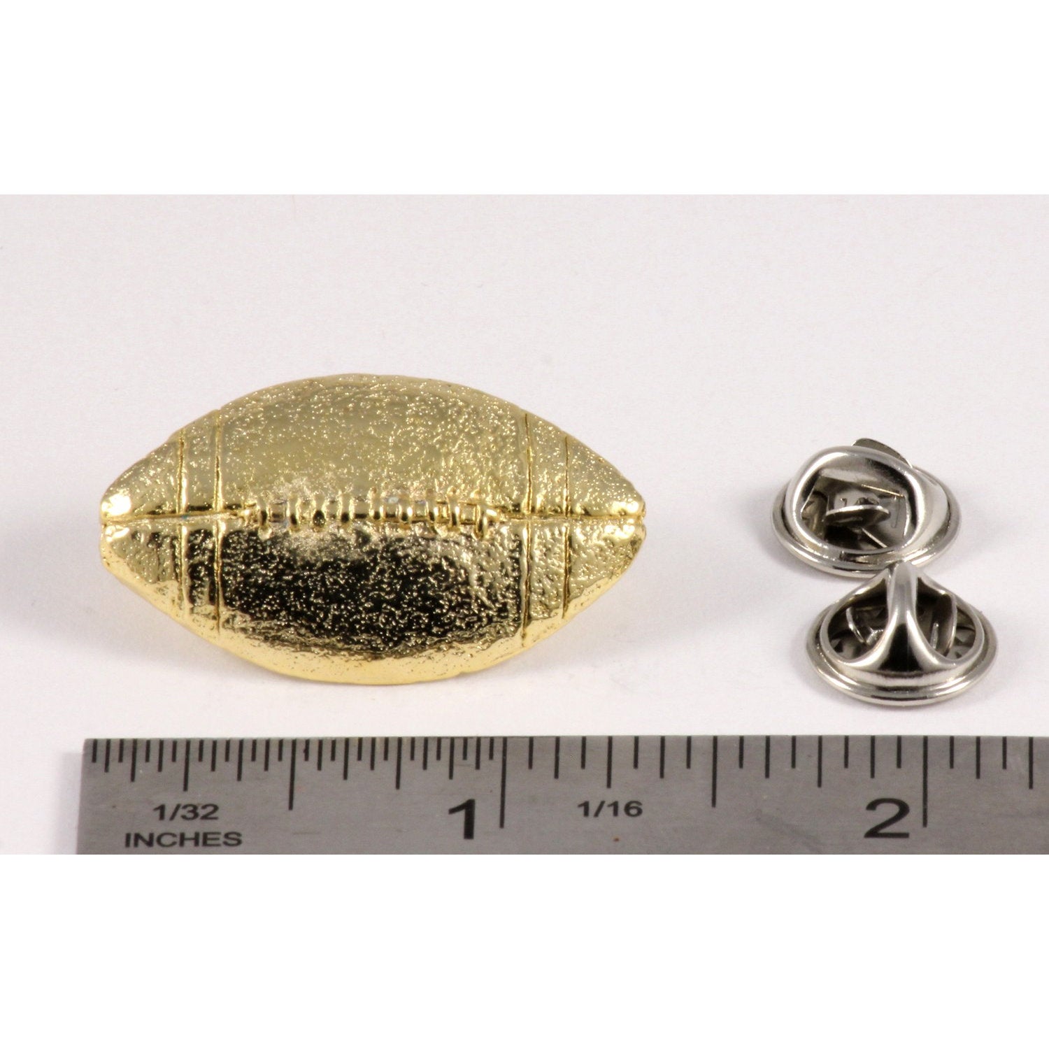 A handcrafted Football Pin next to a ruler, available for sale at Creativeartisan.com - the image offers a sense of scale