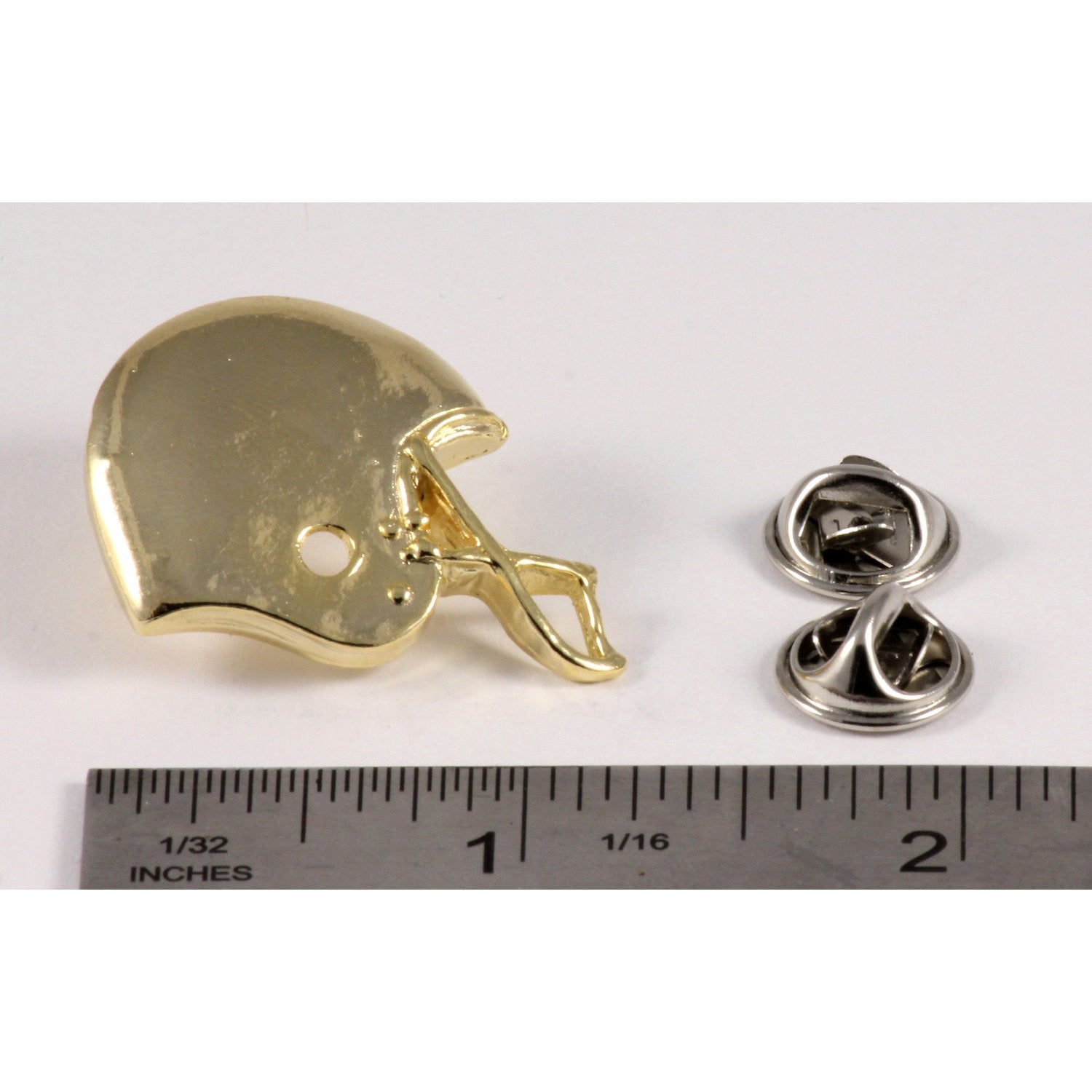 A handcrafted Football Helmet Pin next to a ruler, available for sale at Creativeartisan.com - the image offers a sense of scale