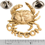 A handcrafted Dungeness Crab Oregon Pin next to a ruler, available for sale at Creativeartisan.com - the image offers a sense of scale