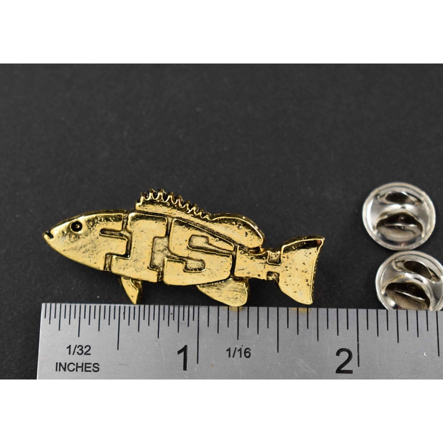 A handcrafted Angel Fish Pin Spelled Out next to a ruler, available for sale at Creativeartisan.com - the image offers a sense of scale